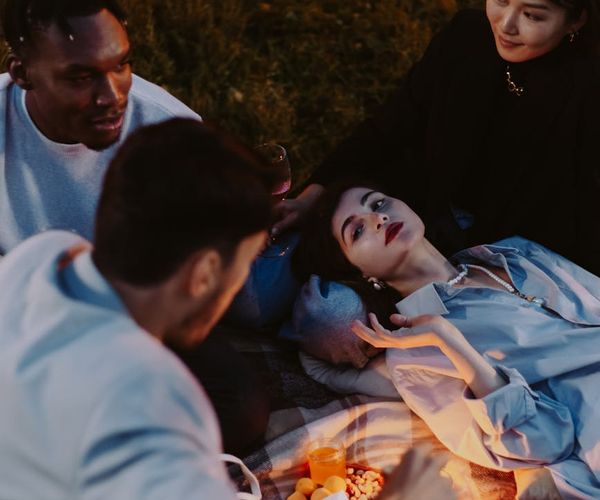 A group of people talking and smiling in a comfortable community space.